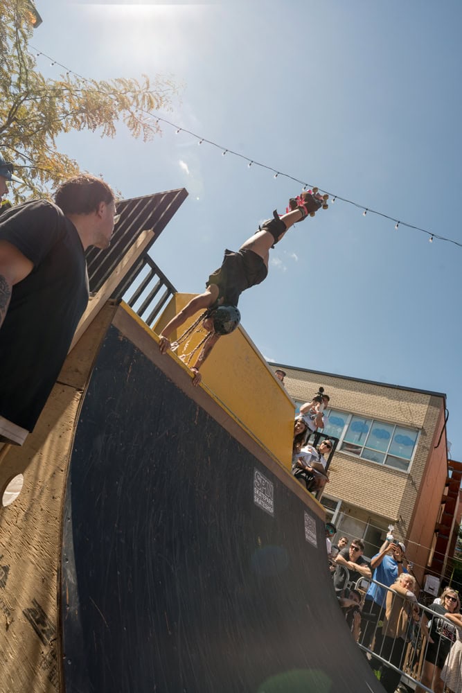 roller skater performing a handstand on a ramp